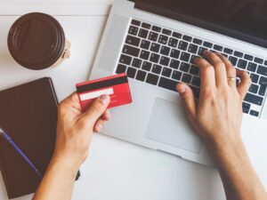 Person using credit card at computer