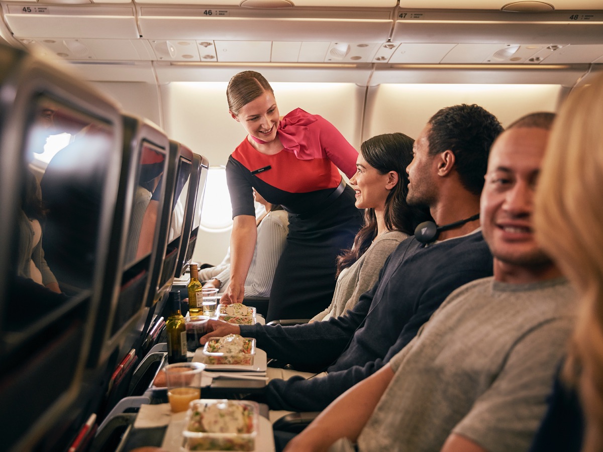 Inflight economy cabin passengers are getting food served in Qantas A330