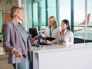 Airport boarding gate agents speak to passenger downgraded