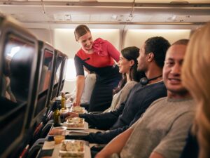 Inflight economy cabin passengers are getting food served in Qantas A330