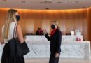 Staff welcome a guest into the Qantas First Lounge in Sydney