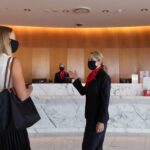 Staff welcome a guest into the Qantas First Lounge in Sydney