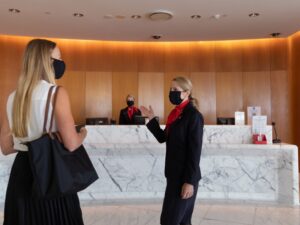 Staff welcome a guest into the Qantas First Lounge in Sydney