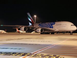 The Emirates A380 returns to Melbourne Airport in February 2022. Qantas planes in background