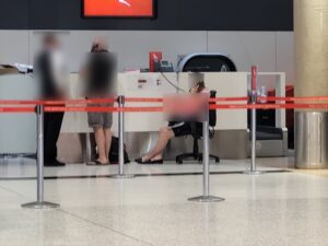 Qantas has "enhanced" the experience for customers at the airport forced to wait hours to speak to the call centre by giving them a chair to sit on while they wait