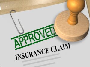 3D illustration of APPROVED stamp title on insurance claim document