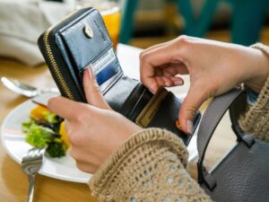 american express cards in wallet at restaurant