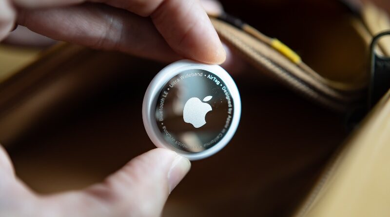 Apple Airtag being placed into checked luggage bag