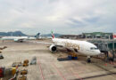 Emirates Boeing 777-300ER at Hong Kong Airport with a Cathay Pacific A350 in the background