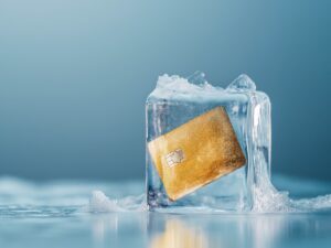 Credit card frozen in ice cube. Frozen bank account. Frozen funds and assets, unavailable money. The concept of bankruptcy and capital freezing, capital outflow restrictions, deposit risk, sanctions.