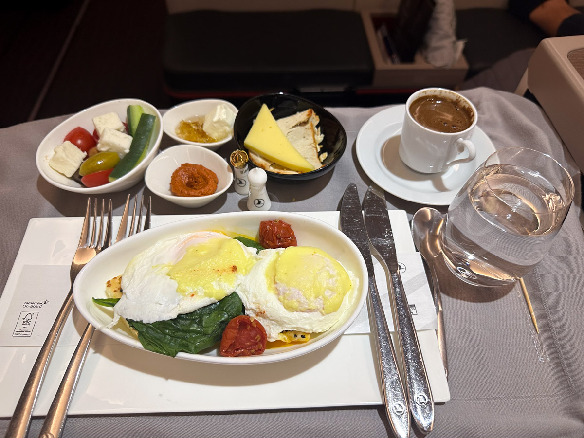 Poached eggs benedit with toasted pide, leaf spinach and light mornay sauce for breakfast in Turkish Airlines business class