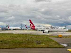 A Qantas Boeing 737-800 and Emirates A380 at Melbourne Airport