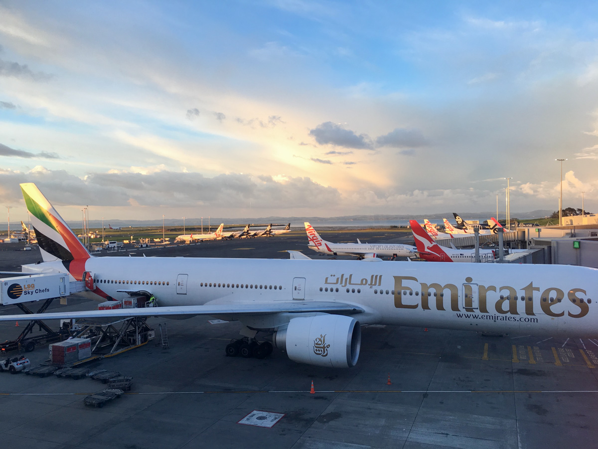 An Emirates 777 at Auckland Airport with Qantas, Air New Zealand, Virgin Australia and Jetstar planes in the background