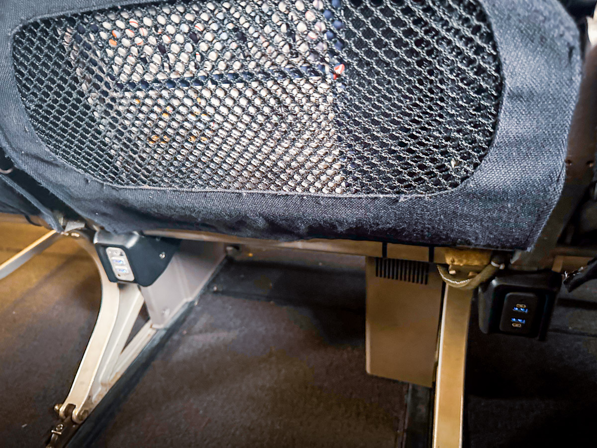 USB charging ports under the seat in Qantas 737 Economy class