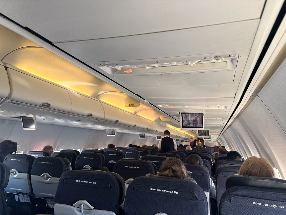 ABC News playing on the overhead TVs in Qantas Economy Class