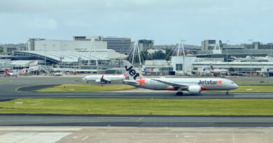 Jetstar Boeing 787-8 lands at Sydney Airport, with Virgin Australia plane in the background