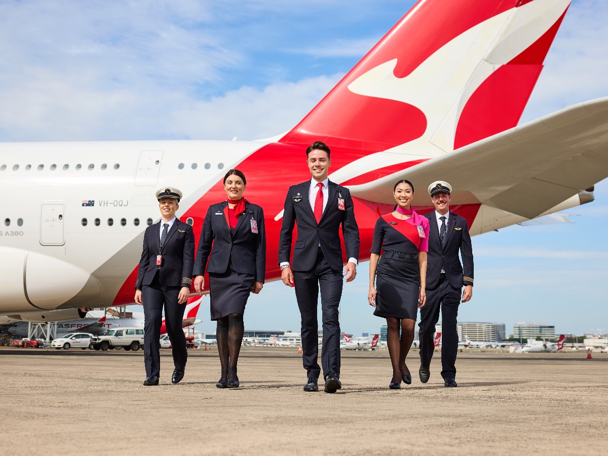 Crew wearing the Martin Grant Qantas crew uniforms in front of a Qantas A380