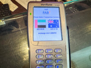 EFTPOS machine offering a choice of UAE Dirhams or AUD for payment with dynamic currency conversion