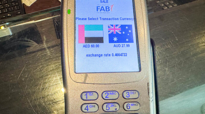 EFTPOS machine offering a choice of UAE Dirhams or AUD for payment with dynamic currency conversion