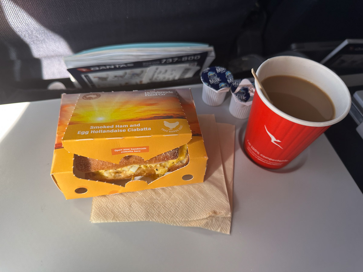 Qantas economy class breakfast on a Brisbane-Sydney flight with an egg ciabatta and coffee