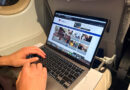 Browsing the Australian Frequent Flyer (AFF) website on a laptop while on a plane