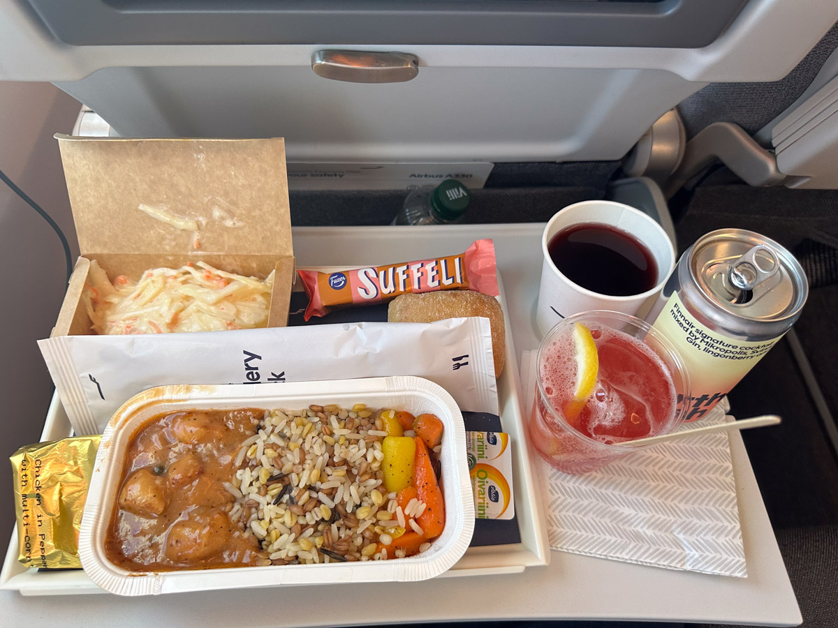 Chicken in pepper sauce with multi-grain rice and rustic carrots, served with coleslaw and a chocolate bar in Finnair Economy Class