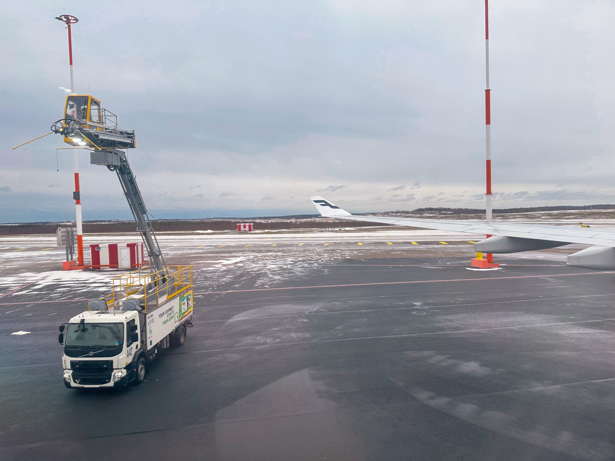 De-icing truck prepares to spray a Finnair A330 in Helsinki during winter