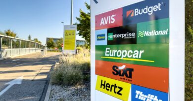 View of multiple rental cars Avis, Budget, Alamo, Enterprise, national, Europcar, Sixt, Hertz, Thrifty in the parking of large international Airport