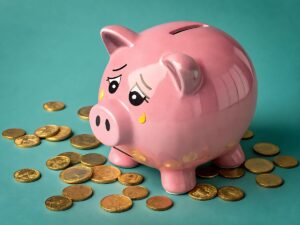 Crying piggy bank with yellow tears