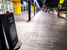 Travel safely sign about unlicensed taxi drivers approaching passengers outside Melbourne Airport Terminal 4