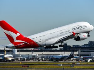 Qantas A380 takes off at Sydney Airport, Air New Zealand and Singapore Airlines in background