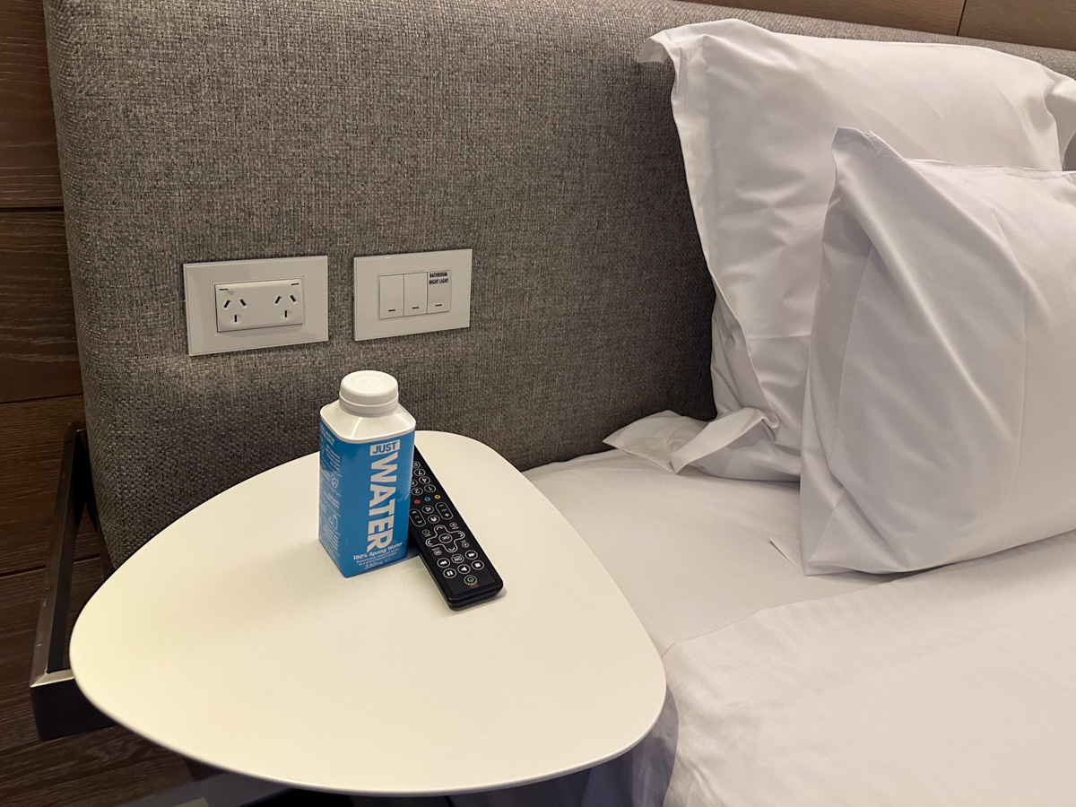 Bottle of water in hotel room on bedside table