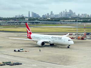 Qantas Boeing 787-9 at Sydney Airport with city in background