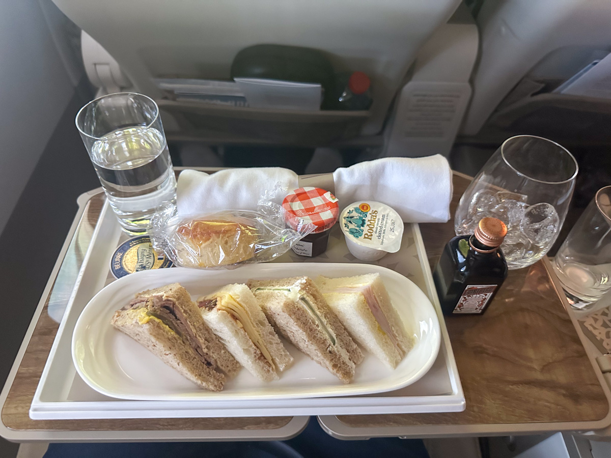 Sandwiches and a raisin scone for afternoon tea in Emirates Premium Economy