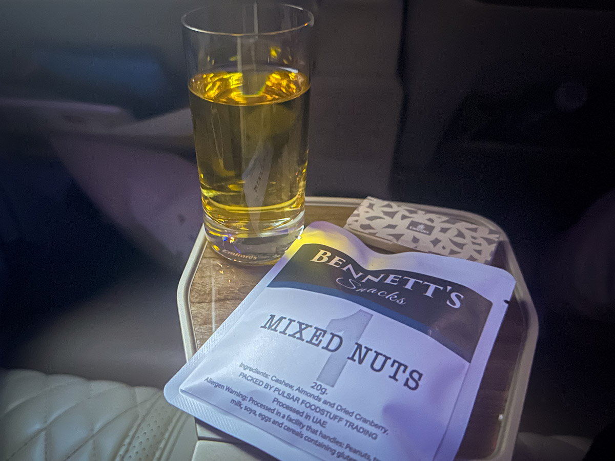 Mixed nuts and juice served mid-flight in Emirates Premium Economy