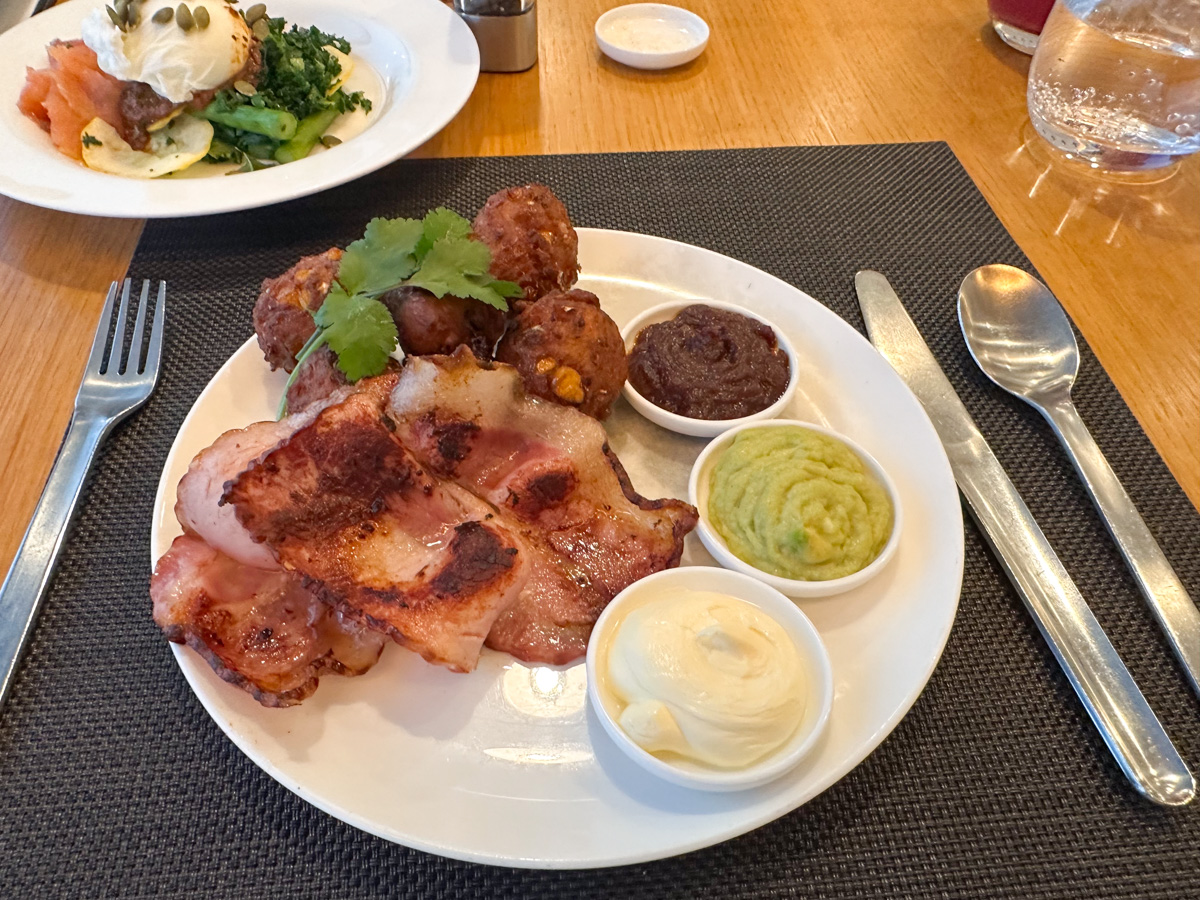 Sweet corn fritters with bacon and a breakfast salad in the Qantas Sydney First Lounge, two dishes from the spring breakfast menu