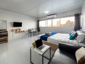 Serviced apartment with bed, sofa, TV and laptop computer