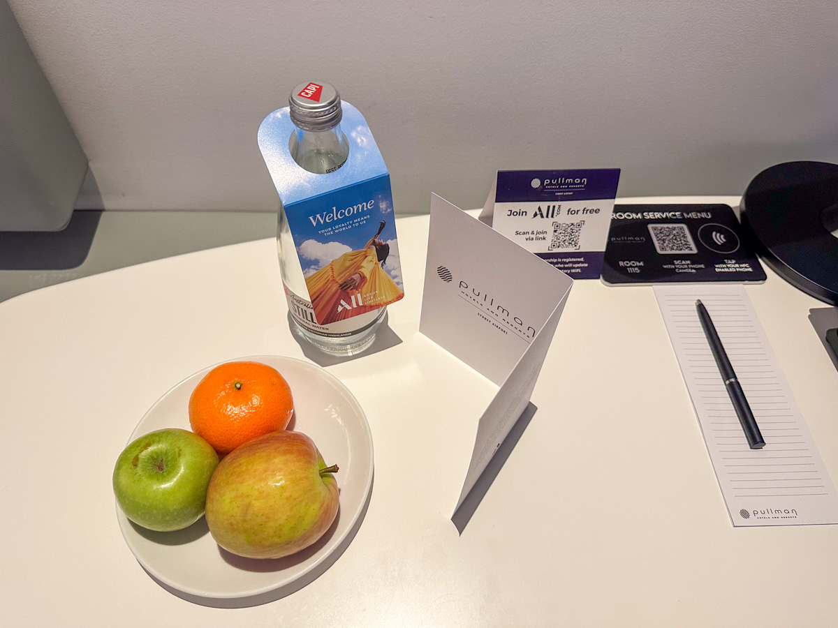 Water bottle and fruit plate in a Pullman Sydney Airport Accor hotel room as a welcome amenity