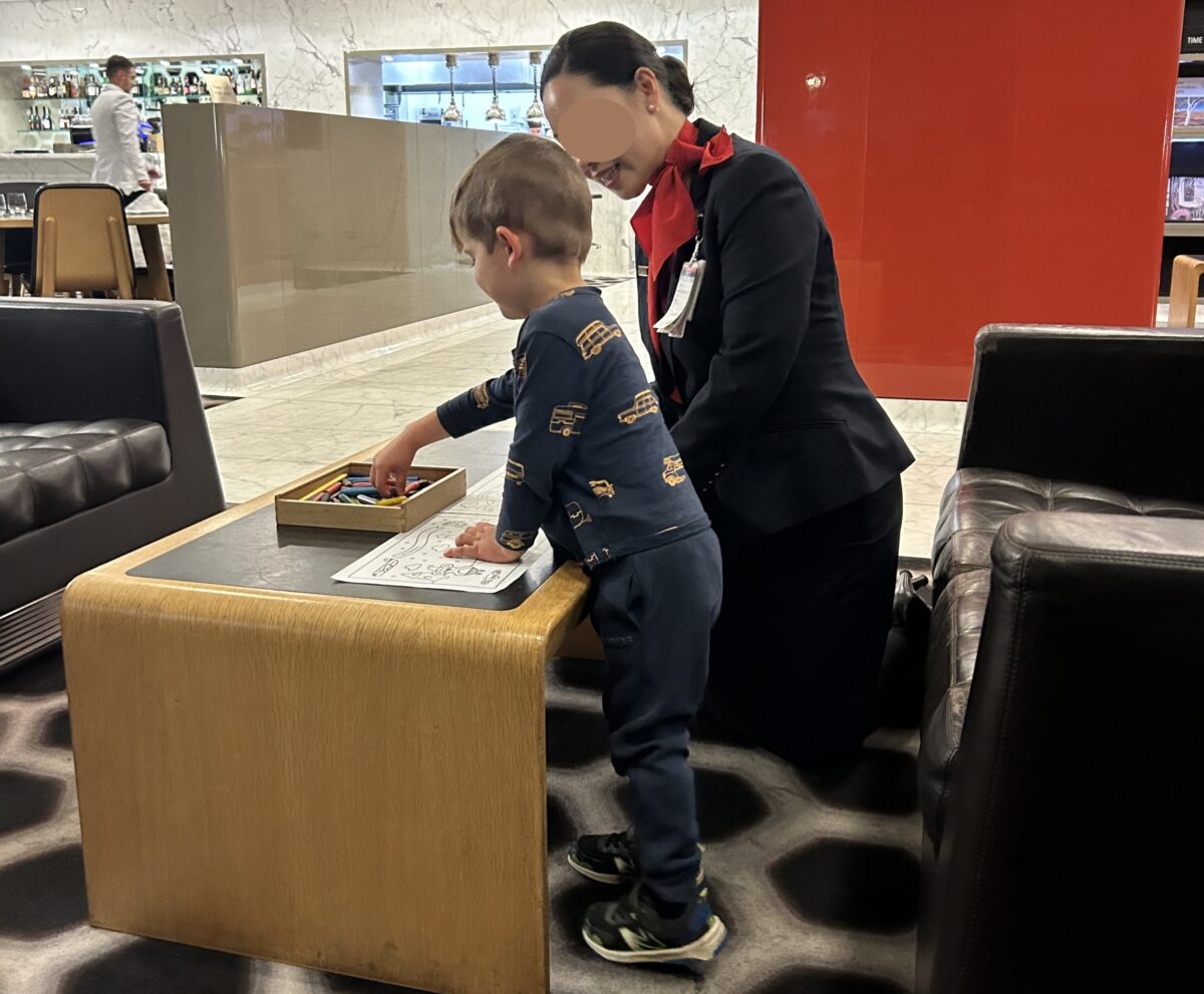 Qantas staff engaging with child at the First Class Lounge