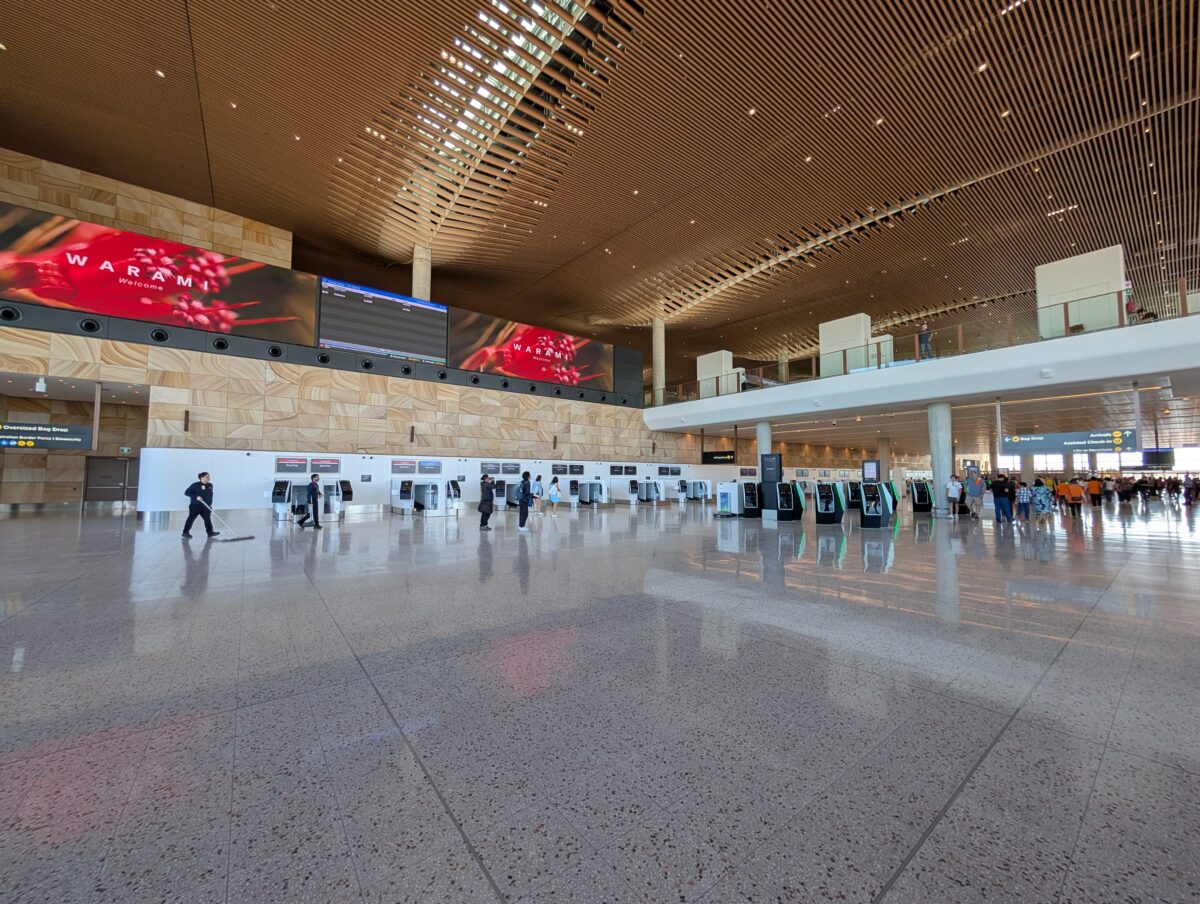 “Self-service check-in kiosks under the tall ceiling of the WSI check-in hall