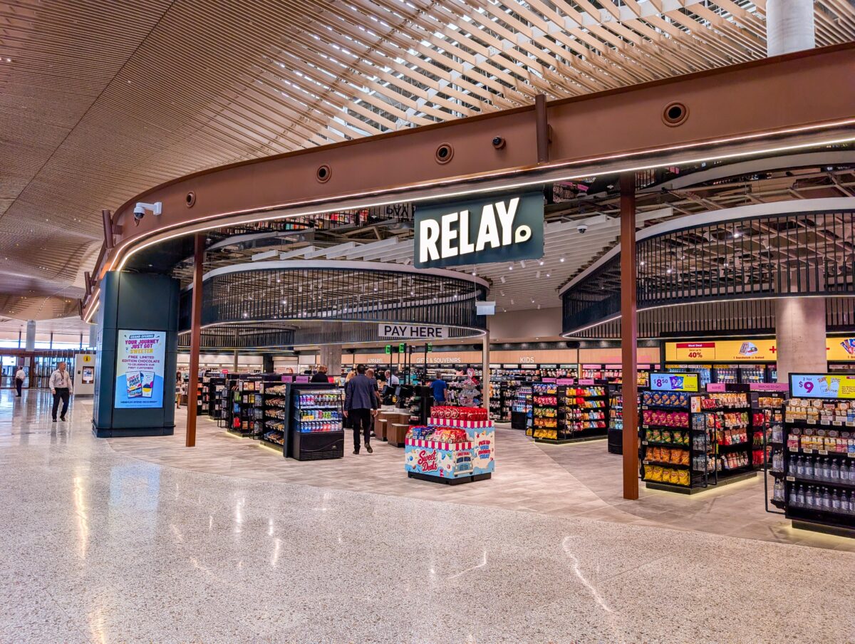 Entrance to the Relay store at Western Sydney International Airport with snacks, drinks and a grand opening sign offering free chocolate