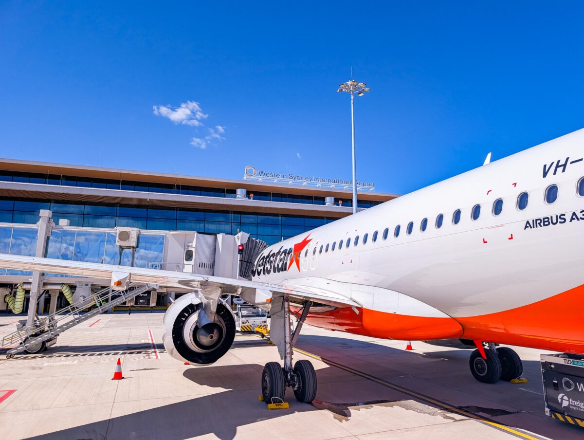Jetstar Airbus A320neo on the apron with the Western Sydney International Airport terminal behind